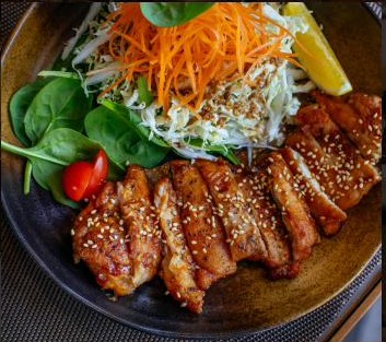 Sesame-crusted grilled chicken with slaw and fresh greens