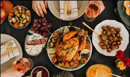 A roast chicken sharing platter with grapes, mushrooms and rosé