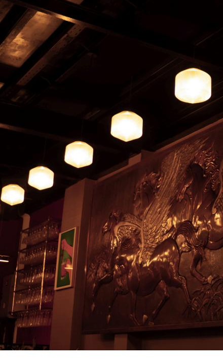 Pendant lights and the bronze Pegasus relief sculpture on the feature wall